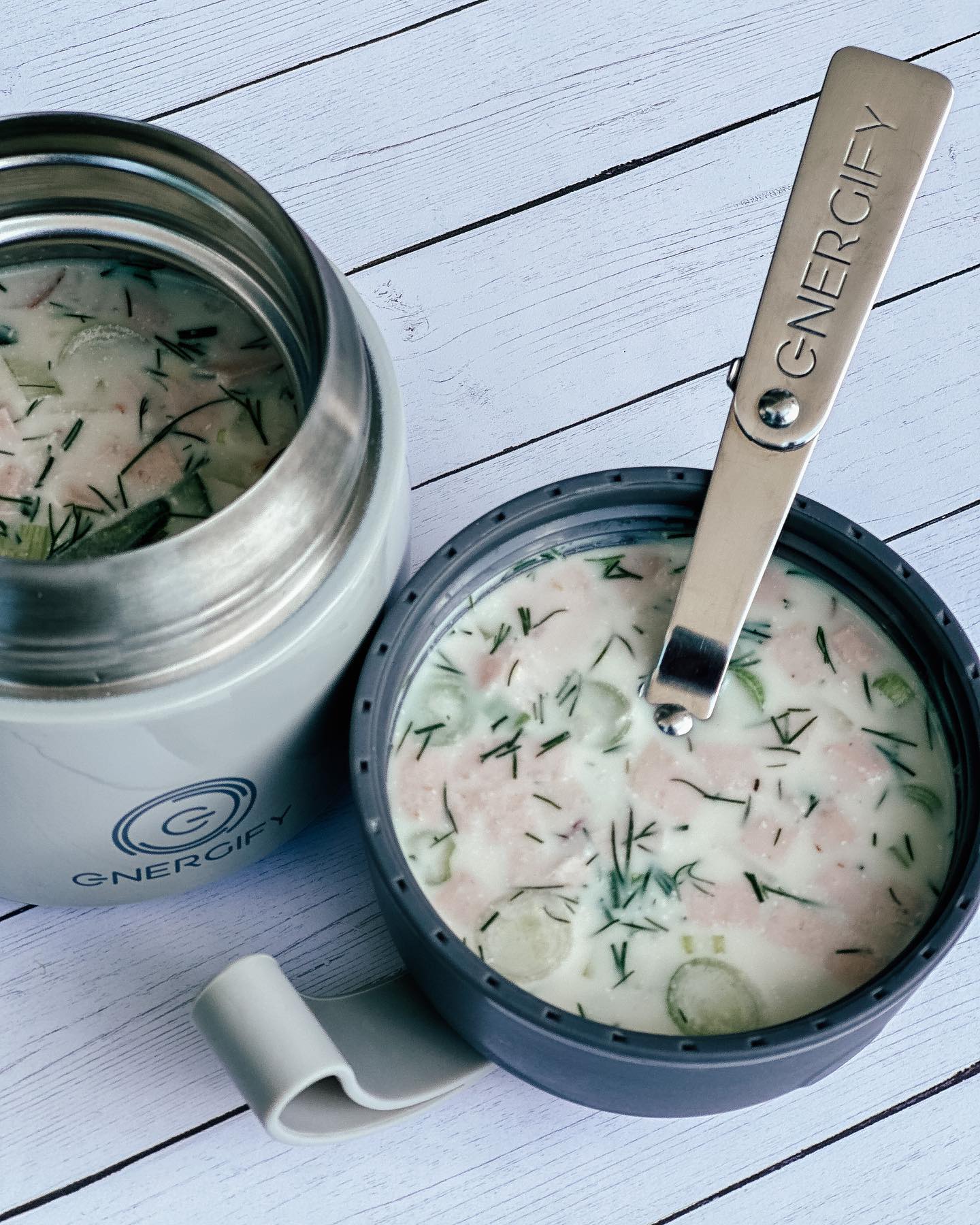 12 oz Titan Gray Energify vacuum insulated food jar with okroshka soup inside. The jar is sitting on a wooden table.
